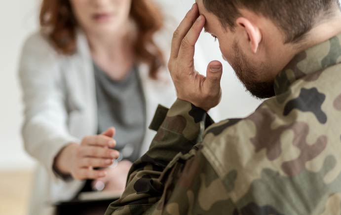 Soldier wearing green uniform during therapy with psychiatrist